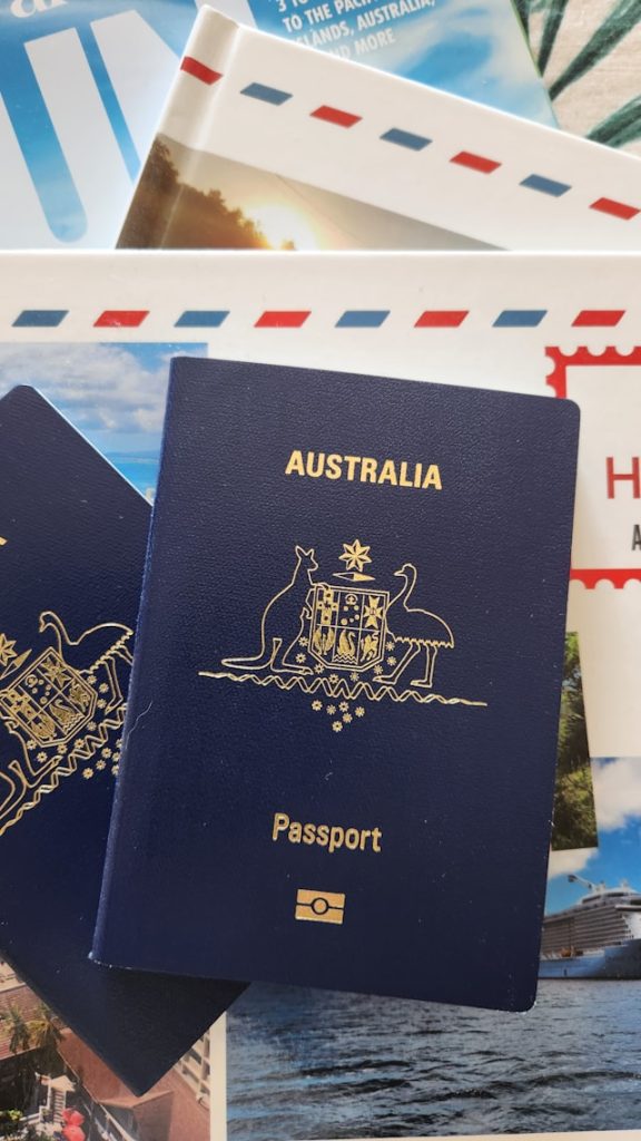 Close up of a traveler holding a passport and showing a digital eTravel QR code on a smartphone.