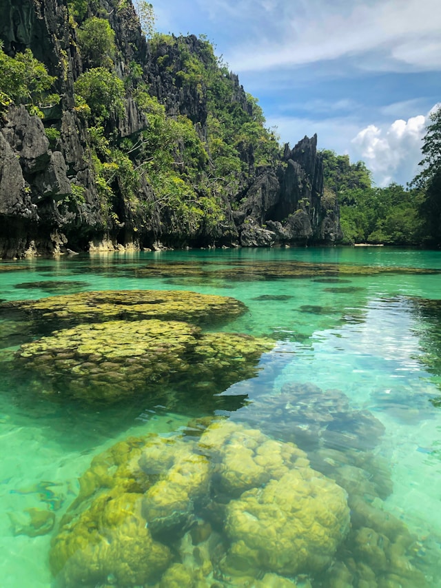 Limestone cliffs and turquoise water of Big Lagoon in El Nido Palawan Philippines.