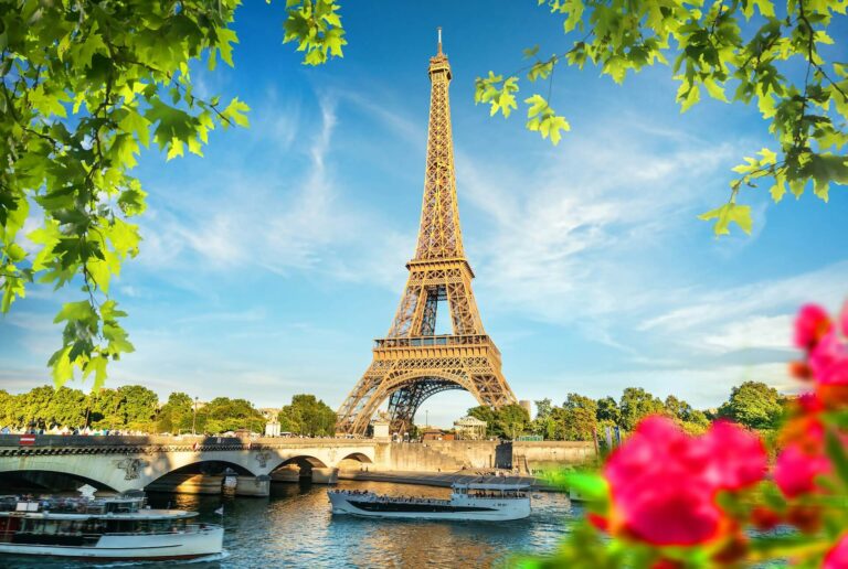 Eiffel Tower in spring with pink flowers in foreground
