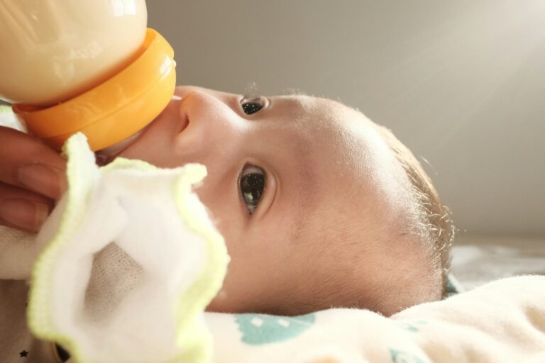 Baby drinking formula from bottle