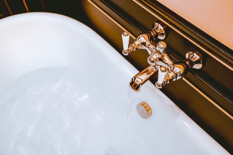 Hotel bath tap with water flowing out