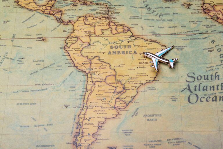 A map with a toy airplane placed representing a family with children travelling through South America on a trip from Australia