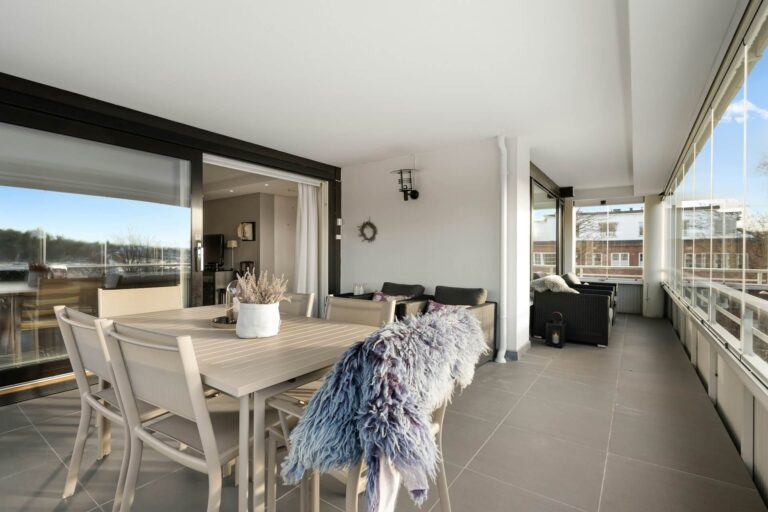 Safe holiday home balcony with dining and seating in enclosed space