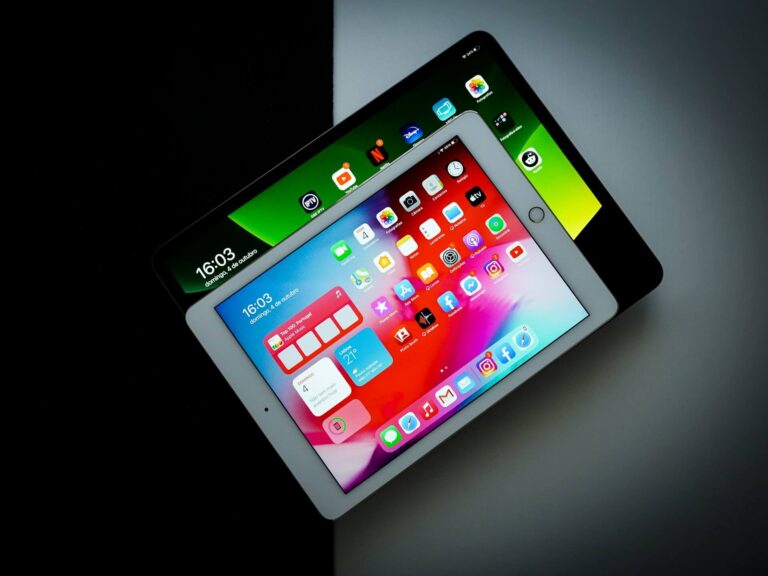 Two tablets switched on with apps