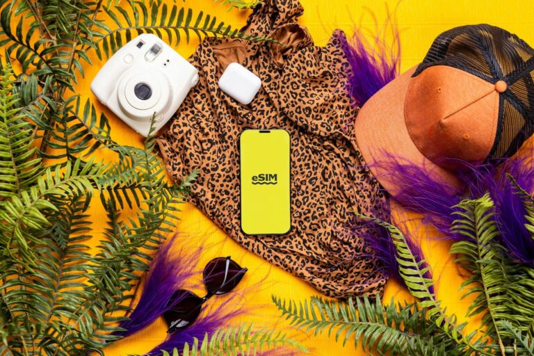 eSim logo on phone with jungle accessories